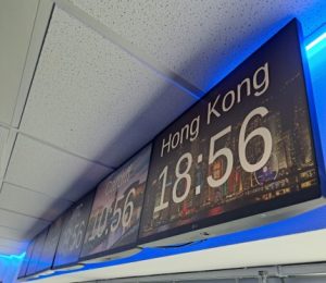 clocks in different time zones on screens