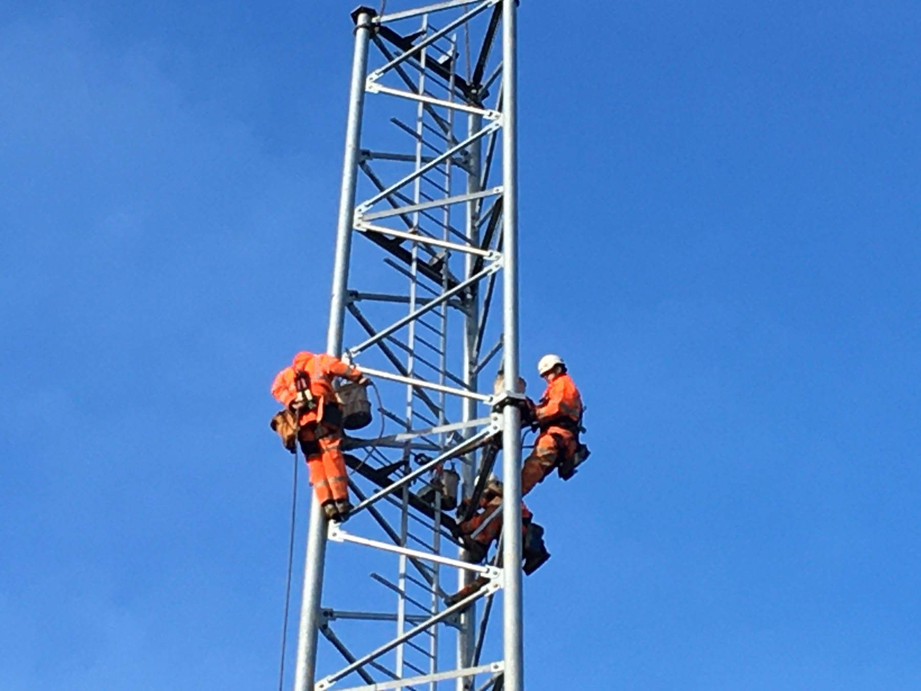 engineers climbing a mobile tower
